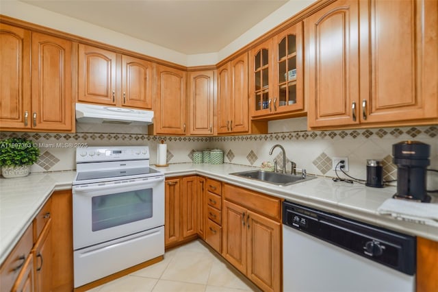 1950 S Ocean Dr Unit 3L, Hallandale Beach, FL 33009 - kitchen featuring white appliances, under cabinet range hood, a sink, glass insert cabinets, and backsplash