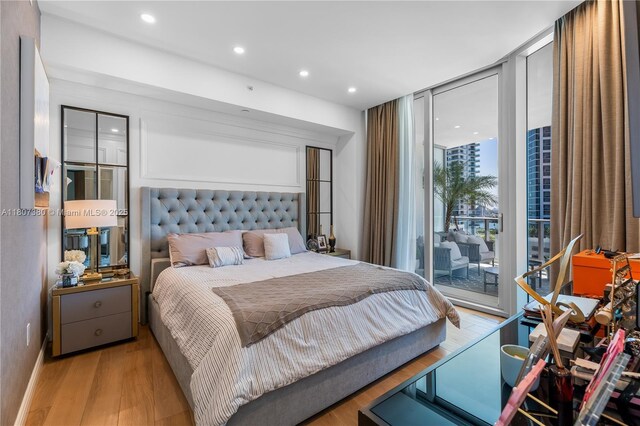 851 NE 1st Ave Unit 1409, Miami, FL 33132 - bedroom with access to outside, wood finished floors, recessed lighting, and expansive windows