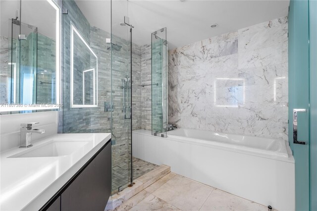851 NE 1st Ave Unit 1409, Miami, FL 33132 - full bath featuring a stall shower, tile walls, a garden tub, vanity, and marble finish flooring