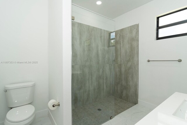 2809 SW 18th St, Lehigh Acres, FL 33976 - bathroom with baseboards, marble finish flooring, toilet, and tiled shower