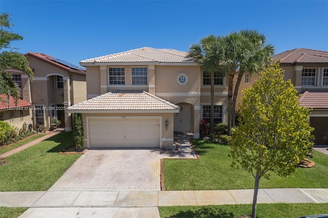17933 SW 33rd Ct, Miramar, FL 33029 - mediterranean / spanish house featuring stucco siding, a tiled roof, driveway, a front yard, and an attached garage