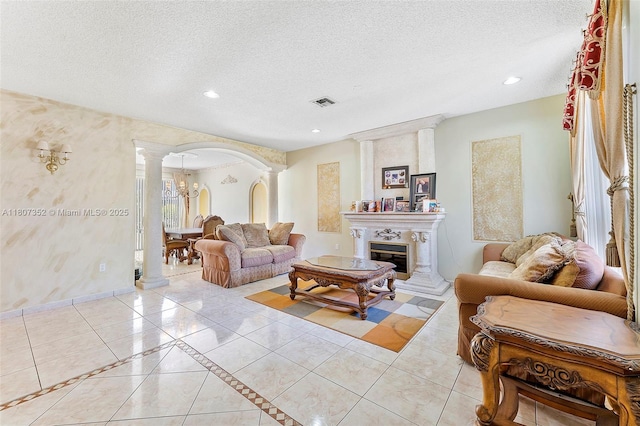17933 SW 33rd Ct, Miramar, FL 33029 - living area with ornate columns, arched walkways, a textured ceiling, light tile patterned floors, and recessed lighting