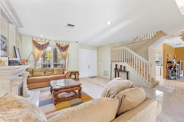17933 SW 33rd Ct, Miramar, FL 33029 - living area featuring stairway, a textured ceiling, washer / dryer, tile patterned flooring, and recessed lighting