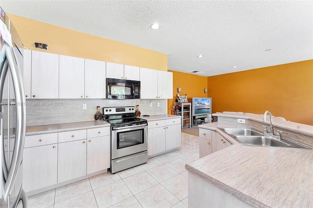 17933 SW 33rd Ct, Miramar, FL 33029 - kitchen featuring appliances with stainless steel finishes, a sink, backsplash, light countertops, and a textured ceiling