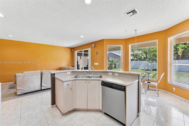 17933 SW 33rd Ct, Miramar, FL 33029 - kitchen with stainless steel dishwasher, a sink, open floor plan, light countertops, and a textured ceiling