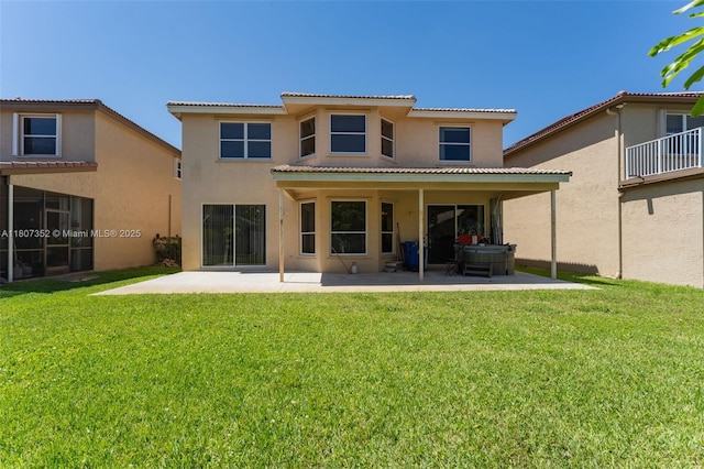 17933 SW 33rd Ct, Miramar, FL 33029 - back of property with a patio, stucco siding, a hot tub, a yard, and a tile roof