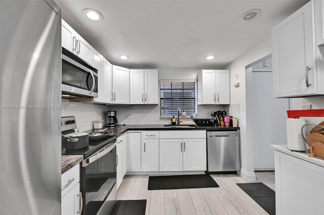 3361 NW 85th Ave Unit 305, Coral Springs, FL 33065 - kitchen featuring stainless steel appliances, a sink, backsplash, white cabinets, and recessed lighting