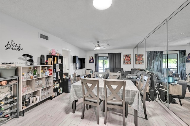 3361 NW 85th Ave Unit 305, Coral Springs, FL 33065 - dining space featuring a textured ceiling, light wood finished floors, healthy amount of natural light, and a ceiling fan