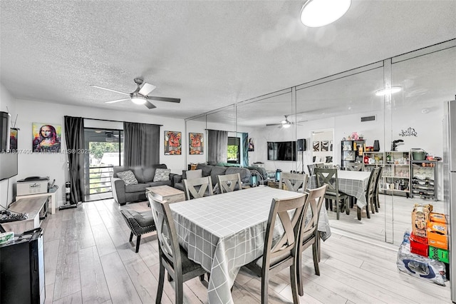 3361 NW 85th Ave Unit 305, Coral Springs, FL 33065 - dining area featuring a ceiling fan, light wood finished floors, and a textured ceiling