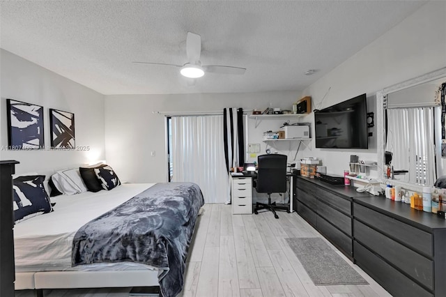 3361 NW 85th Ave Unit 305, Coral Springs, FL 33065 - bedroom with light wood-style flooring, a textured ceiling, an office area, multiple windows, and ceiling fan