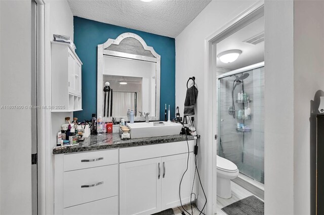 3361 NW 85th Ave Unit 305, Coral Springs, FL 33065 - bathroom with a stall shower, vanity, toilet, and a textured ceiling