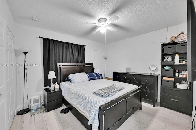 3361 NW 85th Ave Unit 305, Coral Springs, FL 33065 - bedroom with light wood-style floors, ceiling fan, and a textured ceiling