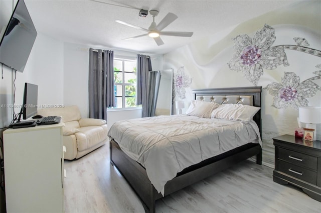 1965 S Ocean Dr Unit Mq, Hallandale Beach, FL 33009 - bedroom featuring light wood-style floors, a textured ceiling, and a ceiling fan