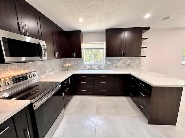 8890 SW 155th Ter, Palmetto Bay, FL 33157 - kitchen featuring appliances with stainless steel finishes, tasteful backsplash, open shelves, dark brown cabinets, and a textured ceiling