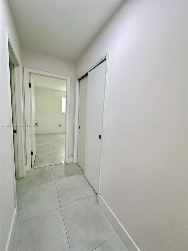 8890 SW 155th Ter, Palmetto Bay, FL 33157 - hallway with baseboards and light tile patterned floors