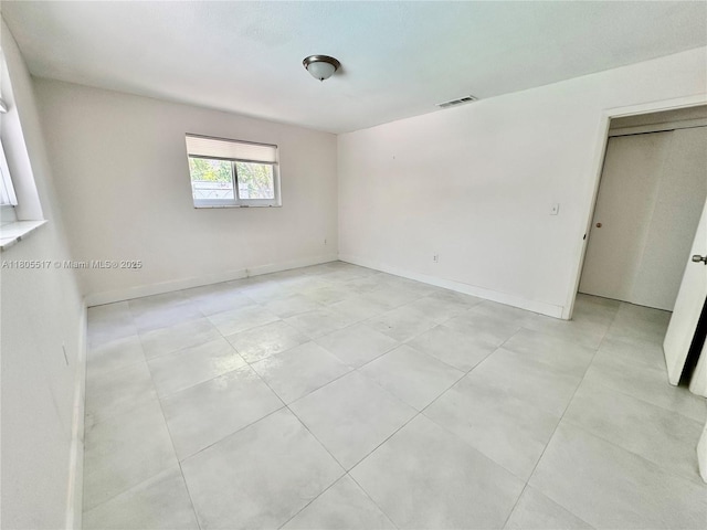 8890 SW 155th Ter, Palmetto Bay, FL 33157 - empty room with light tile patterned floors and baseboards