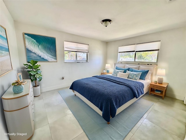 8890 SW 155th Ter, Palmetto Bay, FL 33157 - bedroom featuring multiple windows, light tile patterned floors, and baseboards