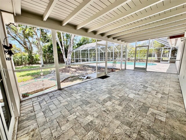 8890 SW 155th Ter, Palmetto Bay, FL 33157 - unfurnished sunroom featuring beamed ceiling