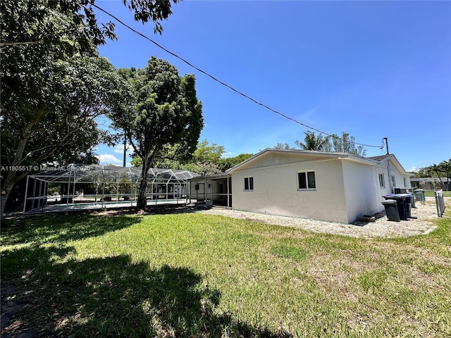 8890 SW 155th Ter, Palmetto Bay, FL 33157 - view of grassy yard with a pool and glass enclosure
