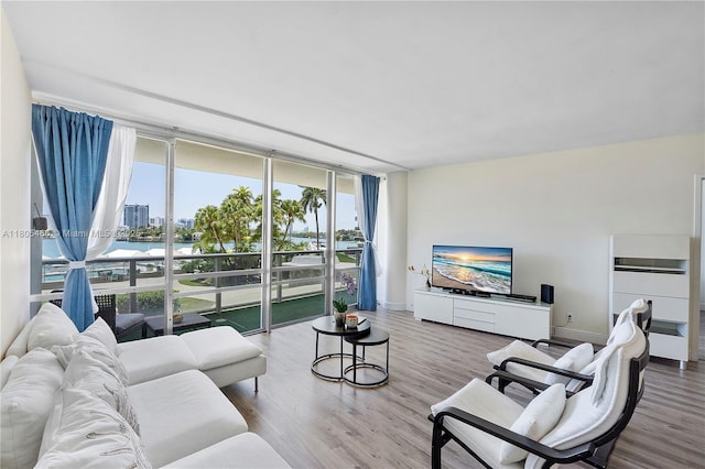 900 Bay Dr Unit 210, Miami Beach, FL 33141 - living area featuring expansive windows, wood finished floors, and baseboards