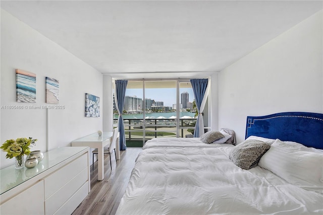 900 Bay Dr Unit 210, Miami Beach, FL 33141 - bedroom featuring floor to ceiling windows, light wood-style floors, access to exterior, and a view of city