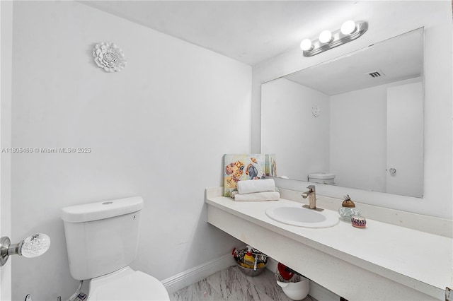 900 Bay Dr Unit 210, Miami Beach, FL 33141 - half bathroom with toilet, a sink, marble finish floors, and baseboards