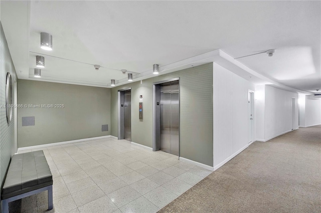 900 Bay Dr Unit 210, Miami Beach, FL 33141 - corridor featuring elevator and baseboards
