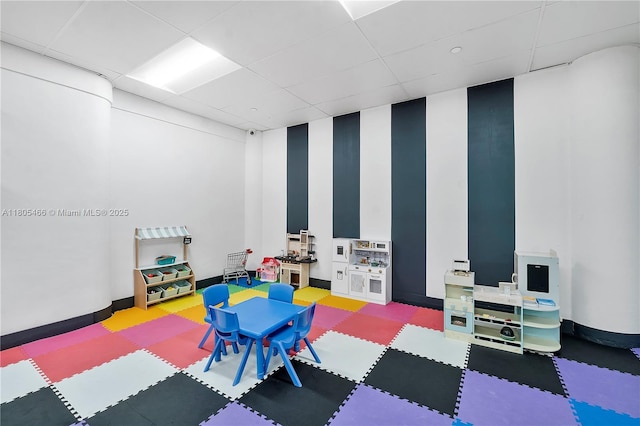 900 Bay Dr Unit 210, Miami Beach, FL 33141 - rec room featuring a paneled ceiling, baseboards, and tile patterned floors