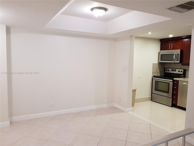 3730 Inverrary Dr Unit 2N, Lauderhill, FL 33319 - kitchen with appliances with stainless steel finishes, recessed lighting, tasteful backsplash, baseboards, and a tray ceiling
