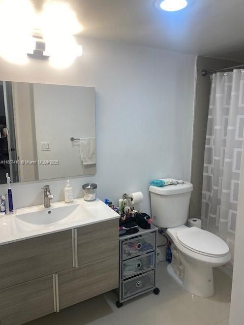 2801 NE 183rd St Unit 1011W, Aventura, FL 33160 - full bath with toilet, vanity, a shower with shower curtain, and tile patterned flooring
