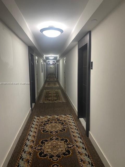 2801 NE 183rd St Unit 1011W, Aventura, FL 33160 - hallway with baseboards and carpet floors