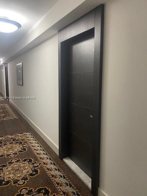 2801 NE 183rd St Unit 1011W, Aventura, FL 33160 - hallway featuring carpet and baseboards