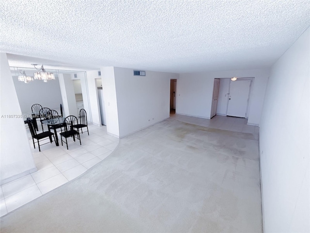 250 174th St Unit 601, Sunny Isles Beach, FL 33160 - spare room featuring light carpet, a textured ceiling, and light tile patterned floors
