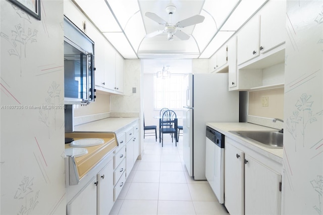 250 174th St Unit 601, Sunny Isles Beach, FL 33160 - kitchen with dishwashing machine, stainless steel microwave, a sink, a ceiling fan, and light countertops