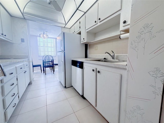 250 174th St Unit 601, Sunny Isles Beach, FL 33160 - kitchen featuring a sink, light countertops, dishwasher, a chandelier, and tasteful backsplash