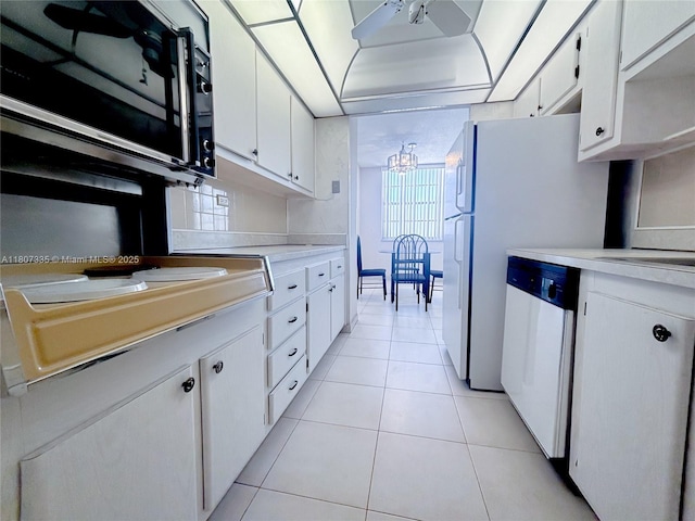 250 174th St Unit 601, Sunny Isles Beach, FL 33160 - kitchen with dishwashing machine, light countertops, a chandelier, and white cabinets