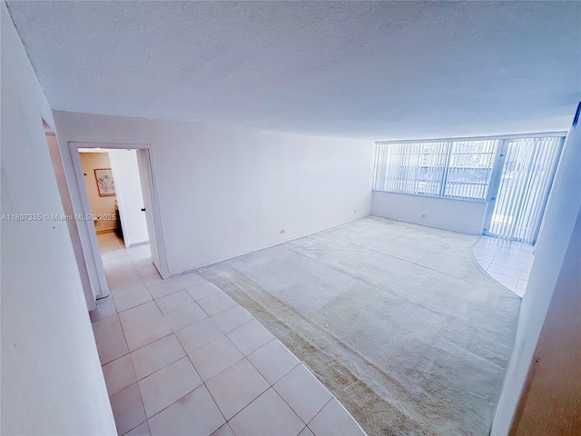 250 174th St Unit 601, Sunny Isles Beach, FL 33160 - tiled empty room with carpet floors and a textured ceiling