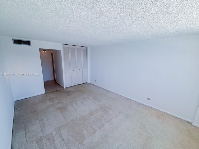 250 174th St Unit 601, Sunny Isles Beach, FL 33160 - unfurnished bedroom with a textured ceiling, carpet, a closet, and baseboards