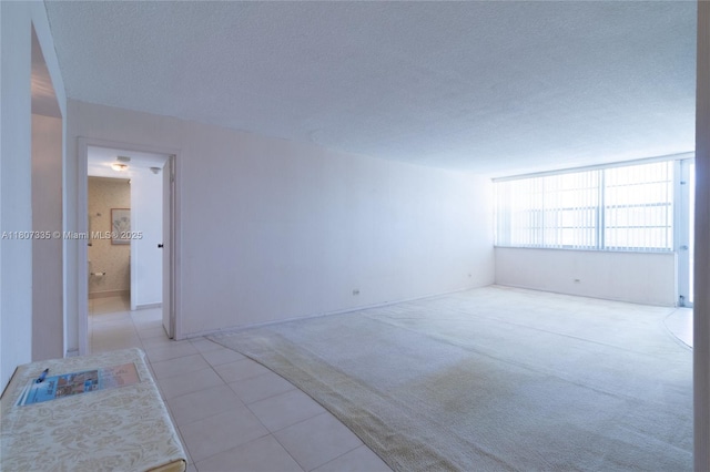 250 174th St Unit 601, Sunny Isles Beach, FL 33160 - tiled empty room featuring a textured ceiling and carpet flooring