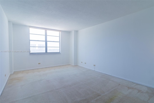 250 174th St Unit 601, Sunny Isles Beach, FL 33160 - unfurnished room featuring carpet floors, a textured ceiling, and baseboards