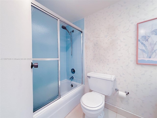 250 174th St Unit 601, Sunny Isles Beach, FL 33160 - bathroom featuring wallpapered walls, combined bath / shower with glass door, toilet, baseboards, and tile patterned floors