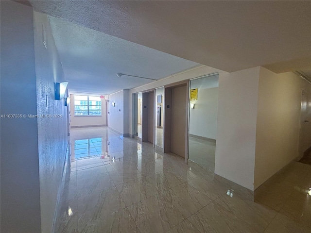 250 174th St Unit 601, Sunny Isles Beach, FL 33160 - spare room featuring elevator, marble finish flooring, and a textured ceiling