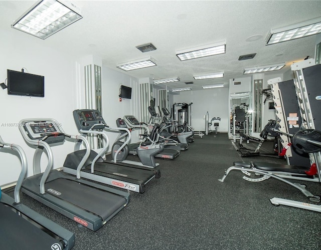 250 174th St Unit 601, Sunny Isles Beach, FL 33160 - gym featuring a textured ceiling