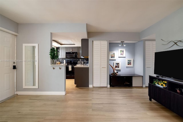 535 Hendricks Isle Unit 303, Fort Lauderdale, FL 33301 - living room with light wood-style floors and baseboards
