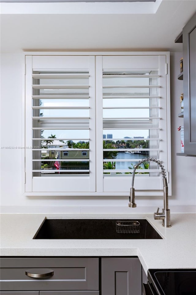 535 Hendricks Isle Unit 303, Fort Lauderdale, FL 33301 - kitchen view of gray cabinetry and light countertops