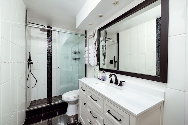 535 Hendricks Isle Unit 303, Fort Lauderdale, FL 33301 - full bath featuring toilet, vanity, a shower stall, tile walls, and tile patterned flooring