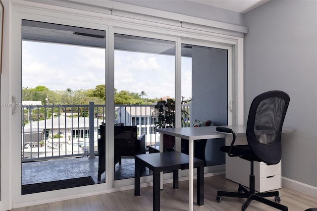 535 Hendricks Isle Unit 303, Fort Lauderdale, FL 33301 - home office with plenty of natural light, wood finished floors, and baseboards