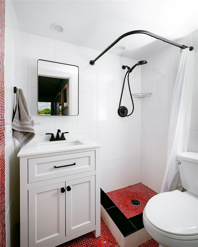 535 Hendricks Isle Unit 303, Fort Lauderdale, FL 33301 - bathroom featuring vanity, toilet, tile walls, a tile shower, and tile patterned floors