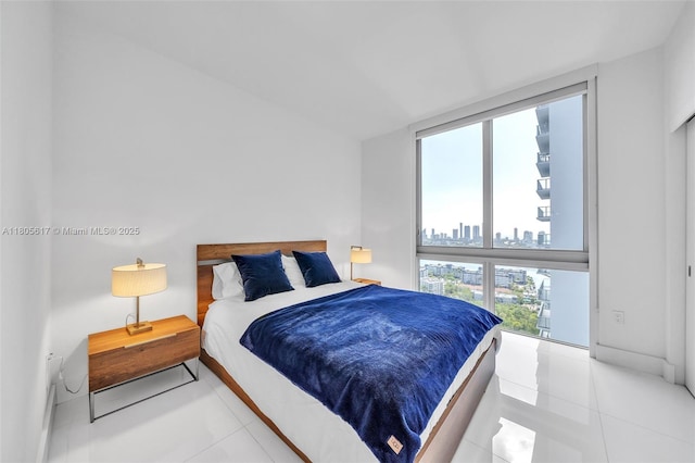 16385 Biscayne Blvd Unit 2707, North Miami Beach, FL 33160 - tiled bedroom with a view of skyline and multiple windows