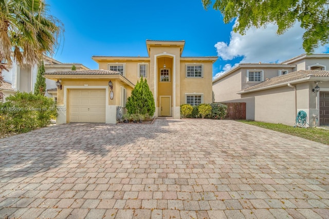 9018 SW 211th Ln, Cutler Bay, FL 33189 - view of front of property featuring decorative driveway, stucco siding, a garage, and a tile roof